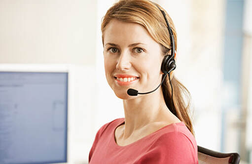 Young mid adult wearing headset sitting in front of the computer photo